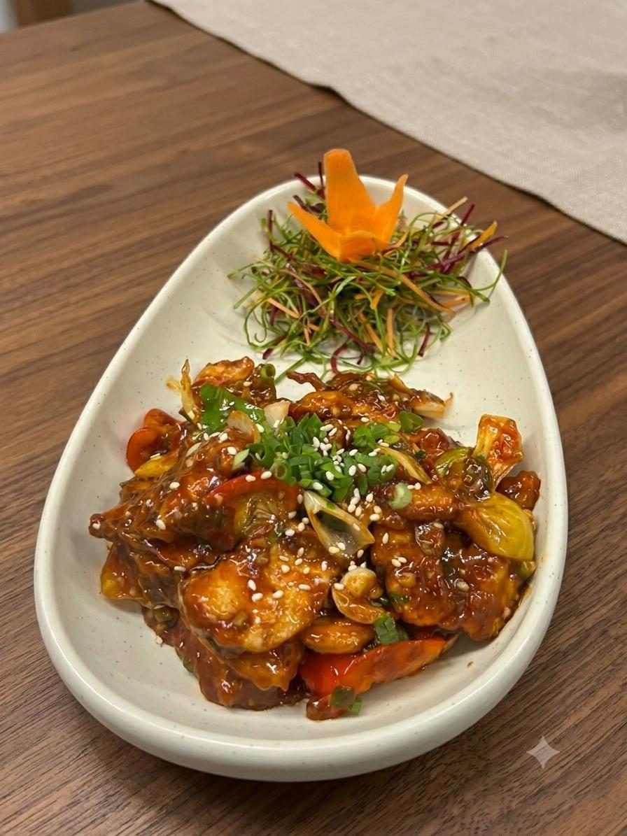 Chilli chicken tossed with peppers and sesame