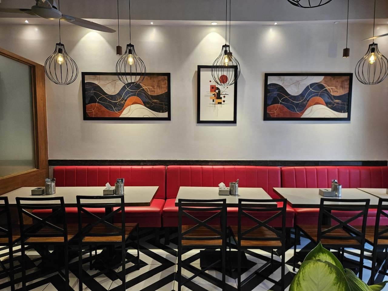 Red booth seating inside Tizzle