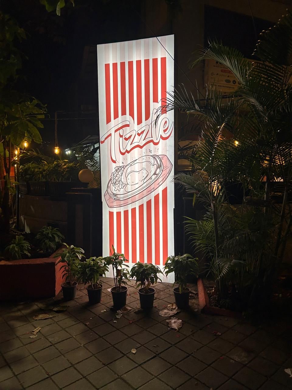 Tizzle sign glowing at night